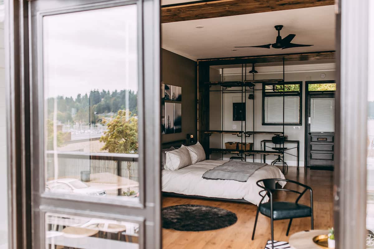 Open industrial loft studio with king bed